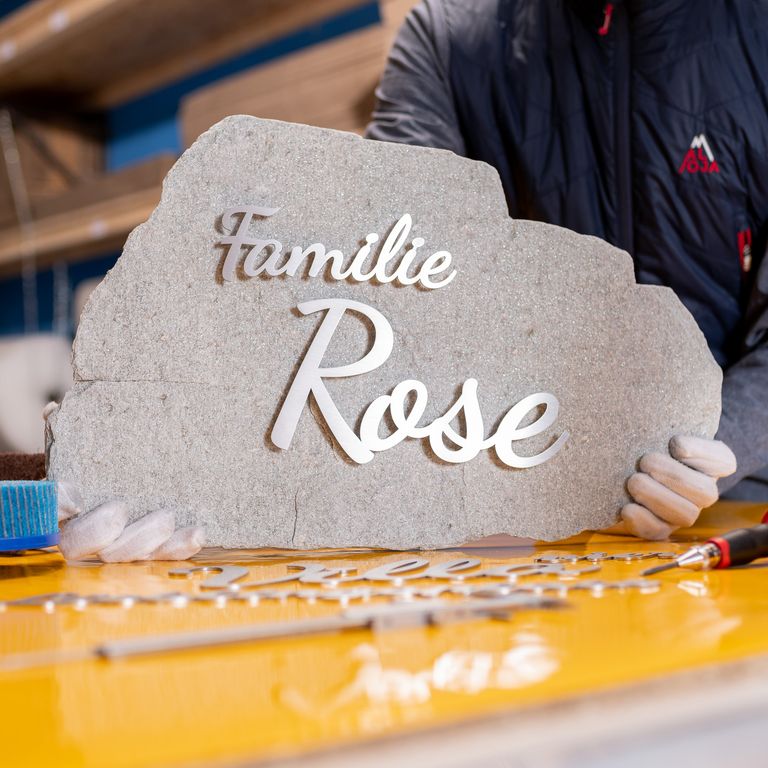 Lettering on boulder Brushed stainless steel lettering on erratic block